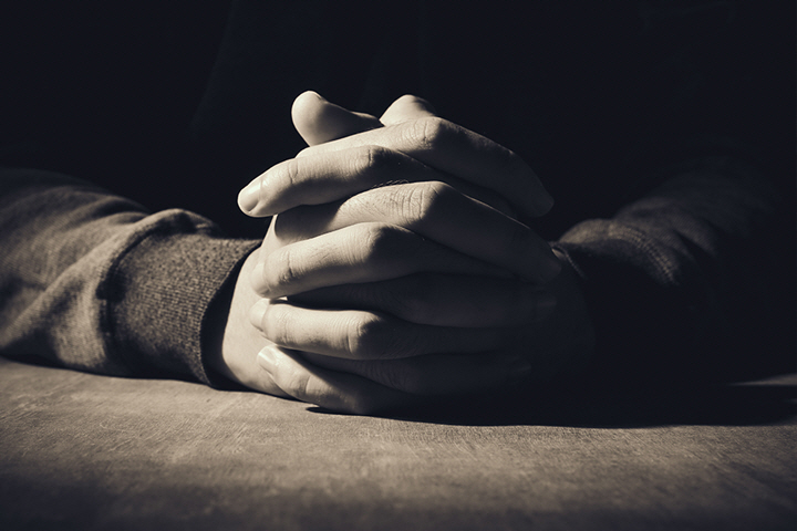 license : https://kr.123rf.com/photo_45806993_praying-hands-of-young-man-on-a-wooden-desk-background.html?downloaded=1